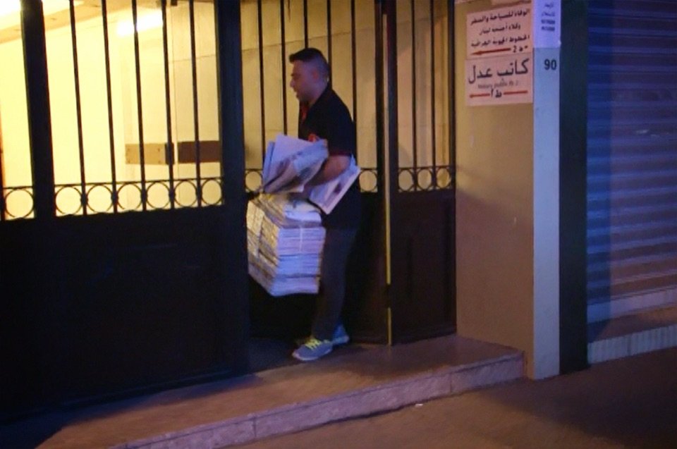 Courier carrying newspapers